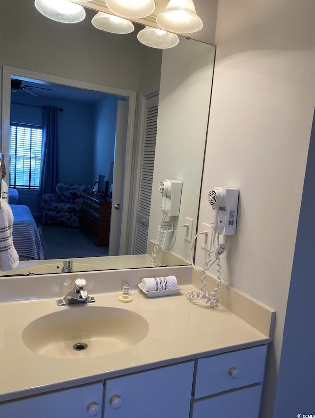 ensuite bathroom featuring vanity and ceiling fan