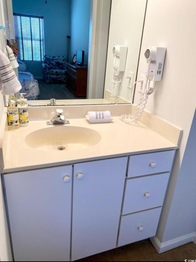 bathroom with vanity and ensuite bath