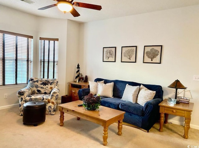 living area with carpet, ceiling fan, and baseboards