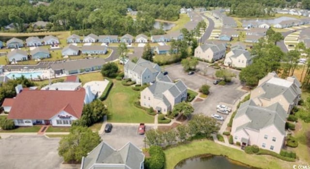 aerial view of property's location featuring nearby suburban area and a large body of water