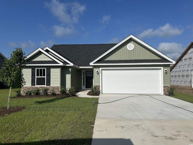 929 Padgett Ln, Conway, SC 29526 - view of front of property with stone siding, a front yard, an attached garage, concrete driveway, and roof with shingles