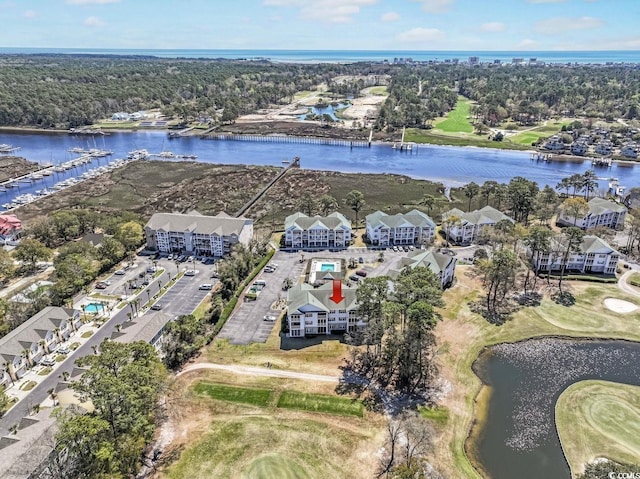 bird's eye view with view of golf course and a water view