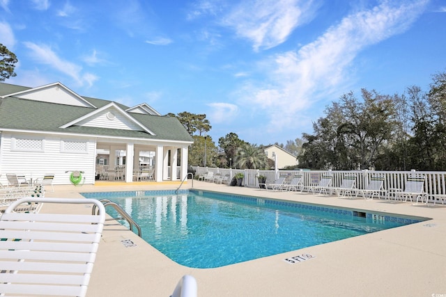pool with fence and a patio area
