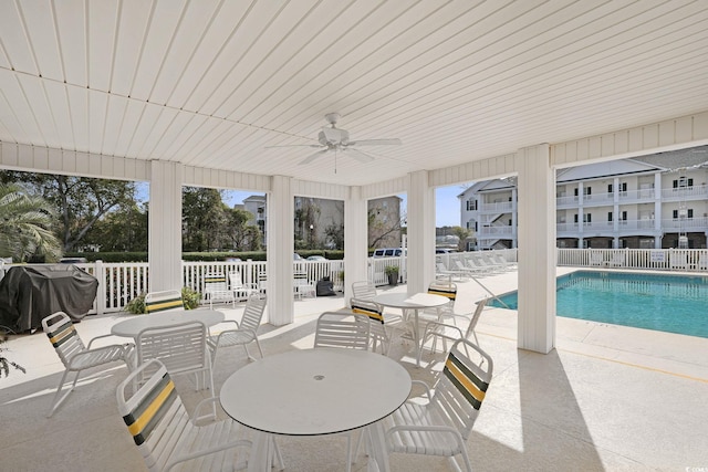 exterior space featuring area for grilling, fence, a ceiling fan, and a patio area