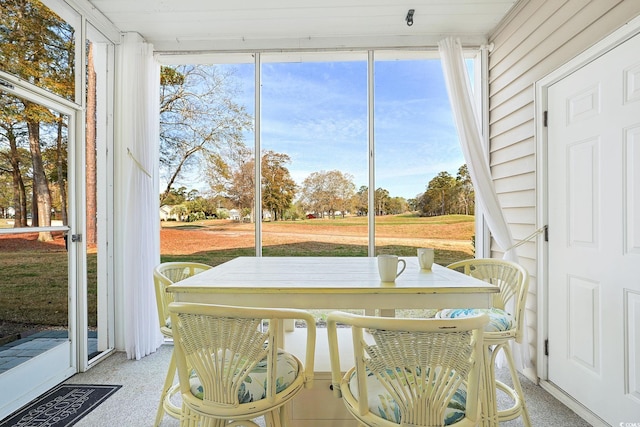 sunroom / solarium featuring a healthy amount of sunlight