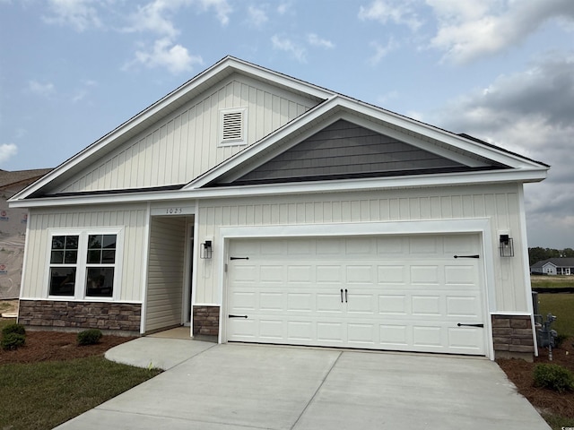 1025 Jase Dr, Longs, SC 29568 - view of front of house with stone siding, concrete driveway, and a garage