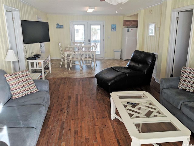 living room featuring crown molding, ceiling fan, wood-type flooring, and french doors