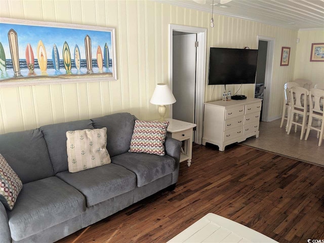 living area with ceiling fan and dark wood-style floors