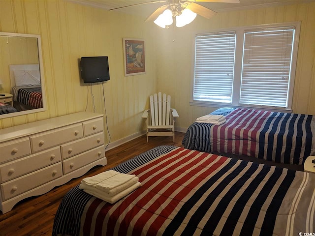 bedroom with baseboards, a ceiling fan, dark wood-style floors, and ornamental molding
