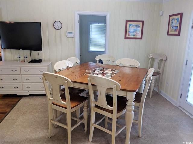 dining area with light tile patterned floors and a healthy amount of sunlight
