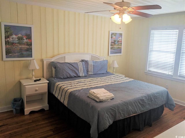 bedroom featuring baseboards, ceiling fan, and wood finished floors