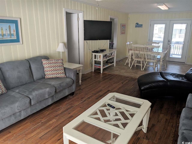 living area with french doors, ornamental molding, and wood finished floors