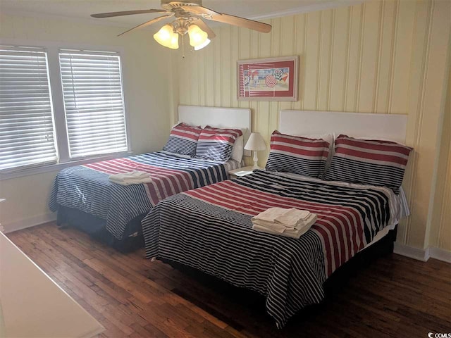 bedroom with baseboards, a ceiling fan, and wood finished floors