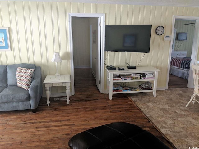 living area featuring baseboards and wood finished floors