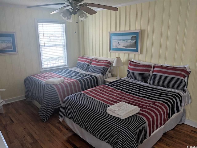 bedroom featuring baseboards, ceiling fan, and wood finished floors