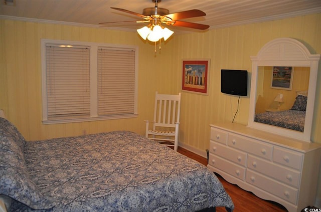 bedroom with baseboards, ornamental molding, a ceiling fan, and dark wood-style floors