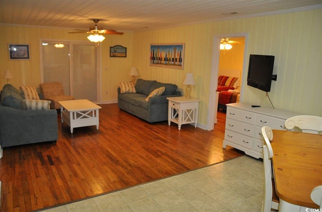 living area with crown molding and ceiling fan