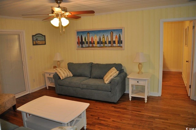 living room with baseboards, ornamental molding, a ceiling fan, and wood finished floors