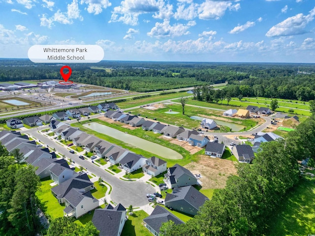 aerial view featuring a wooded view and a residential view