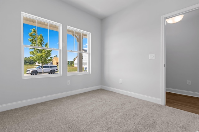 carpeted spare room with baseboards