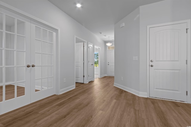 foyer entrance featuring baseboards and wood finished floors