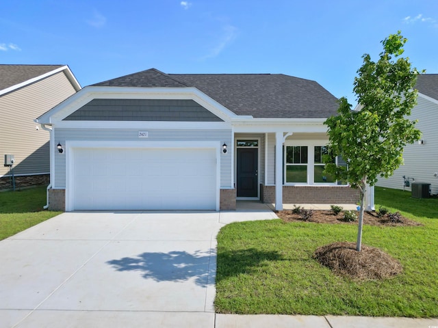view of front facade with central air condition unit, an attached garage, concrete driveway, and a front lawn