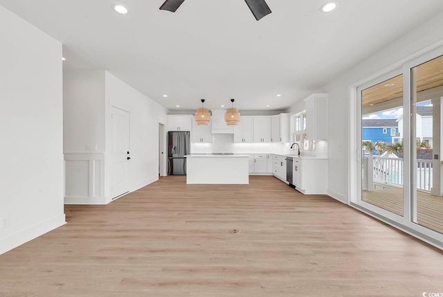 318 Vista Dr, Murrells Inlet, SC 29576 - kitchen with appliances with stainless steel finishes, a kitchen island, light countertops, white cabinetry, and ceiling fan