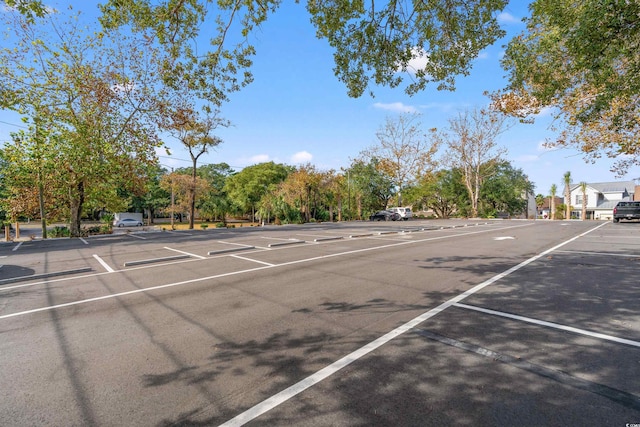 2010 S Ocean Blvd, Myrtle Beach, SC 29577 - uncovered parking lot featuring view of wooded area