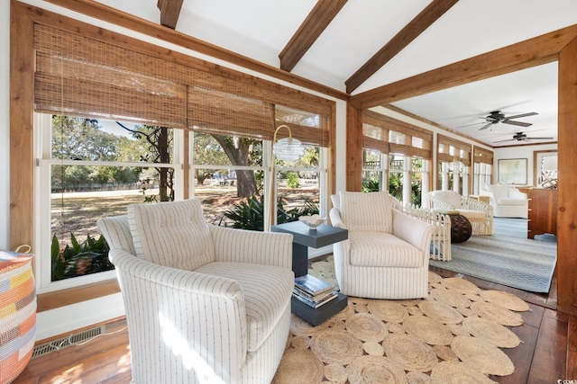 sunroom with visible vents, wood finished floors, and lofted ceiling with beams