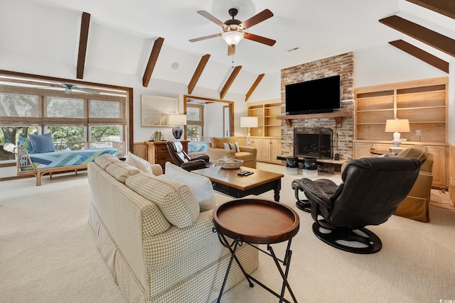 living area featuring visible vents, a brick fireplace, beamed ceiling, ceiling fan, and light colored carpet