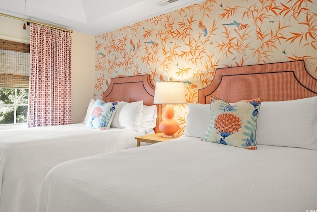 bedroom featuring wallpapered walls and visible vents