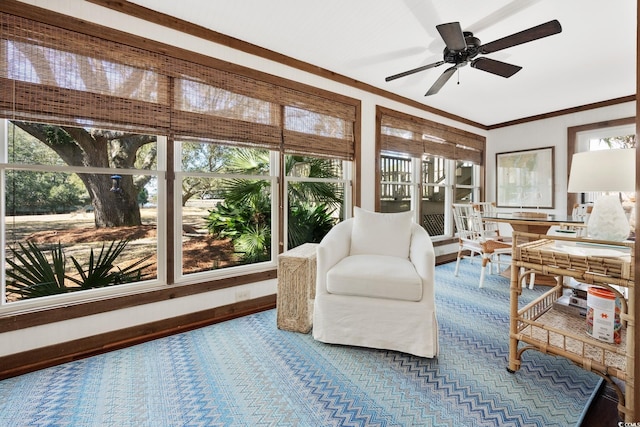 sunroom / solarium with ornamental molding, baseboards, and carpet flooring