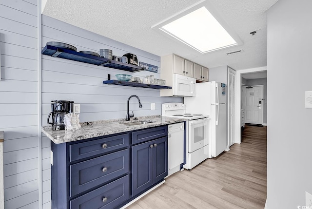 161 Sea Watch Dr Unit 614, Myrtle Beach, SC 29572 - kitchen featuring white appliances, blue cabinetry, a sink, a textured ceiling, and light wood-style floors