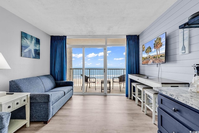 161 Sea Watch Dr Unit 614, Myrtle Beach, SC 29572 - living room featuring a wall of windows, light wood finished floors, and a textured ceiling