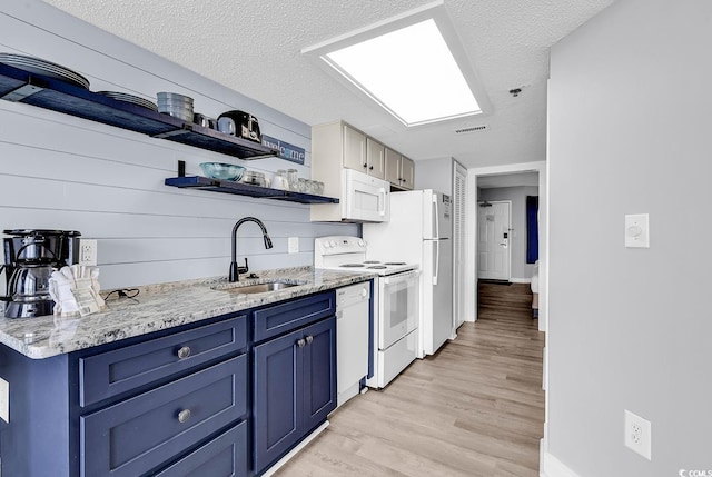161 Sea Watch Dr Unit 614, Myrtle Beach, SC 29572 - kitchen with white appliances, blue cabinetry, a sink, open shelves, and a textured ceiling