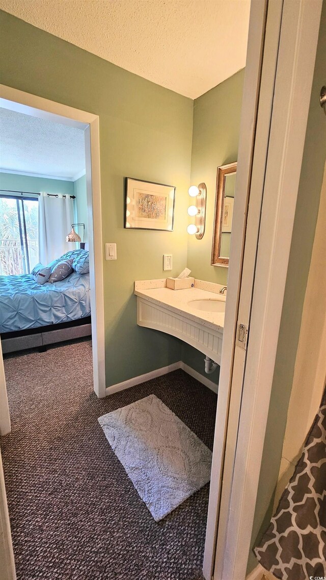 5 Gate 1 Unit 5, Calabash, NC 28467 - ensuite bathroom featuring a textured ceiling and a sink