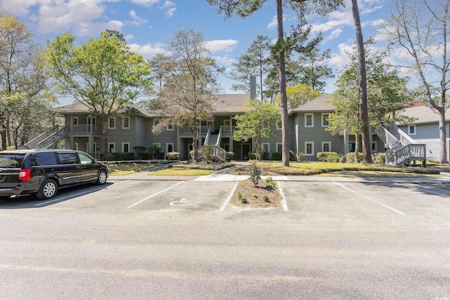 townhome / multi-family property with stairs and uncovered parking