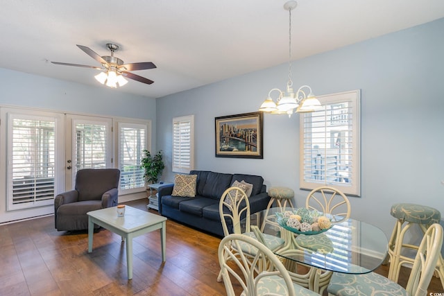 living room with a chandelier, ceiling fan, and wood finished floors