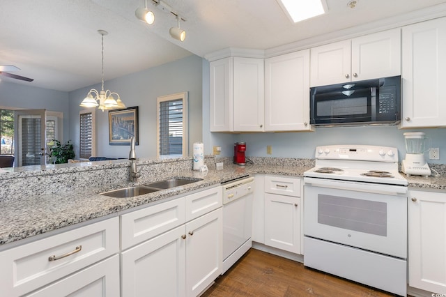 kitchen with white appliances, a sink, white cabinets, and plenty of natural light