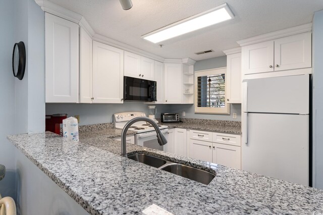 kitchen with white appliances, open shelves, a sink, light stone countertops, and white cabinets