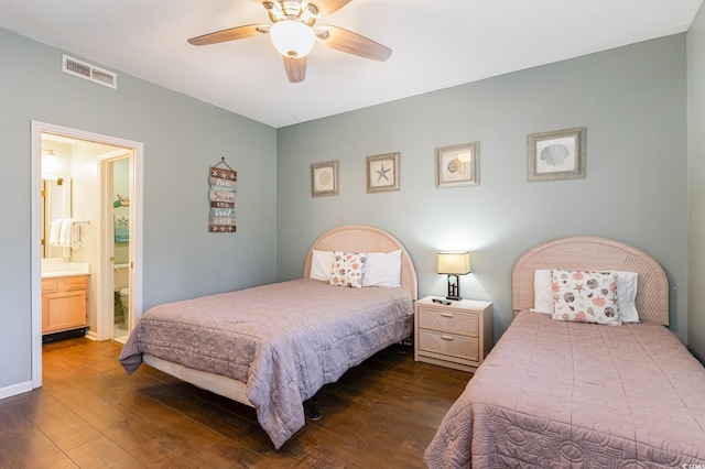bedroom with dark wood-style flooring, connected bathroom, and ceiling fan