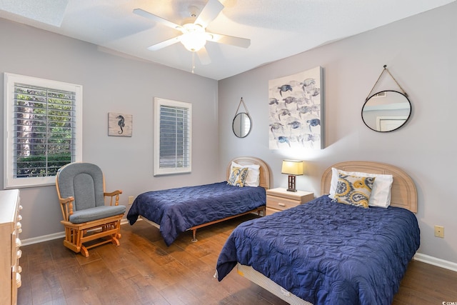 bedroom with wood finished floors, baseboards, and a ceiling fan