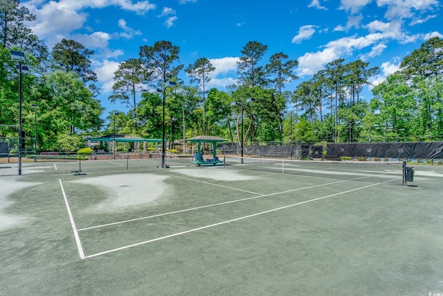 view of tennis court featuring fence
