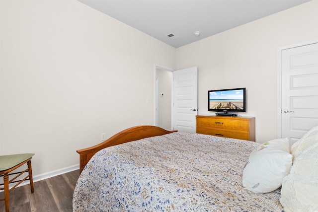 bedroom with dark wood-style floors, baseboards, and visible vents