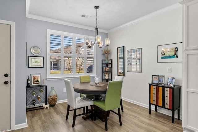212 Machrie Loop Unit D, Myrtle Beach, SC 29588 - dining space featuring crown molding, visible vents, a notable chandelier, and light wood-style floors
