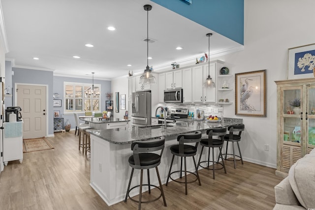 212 Machrie Loop Unit D, Myrtle Beach, SC 29588 - kitchen with a sink, tasteful backsplash, a kitchen breakfast bar, a peninsula, and stainless steel appliances