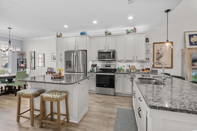 212 Machrie Loop Unit D, Myrtle Beach, SC 29588 - kitchen with crown molding, appliances with stainless steel finishes, a sink, open shelves, and an inviting chandelier