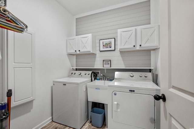 212 Machrie Loop Unit D, Myrtle Beach, SC 29588 - laundry area with light wood-style flooring, cabinet space, wood walls, and separate washer and dryer