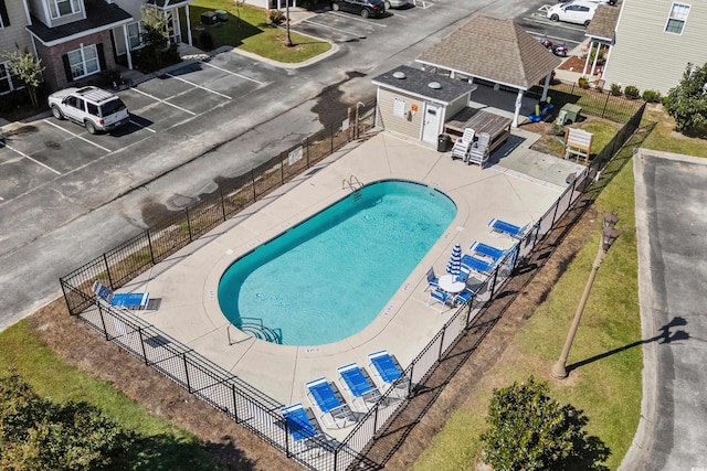 community pool featuring fence and an outbuilding