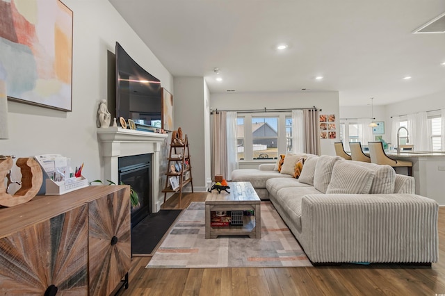 1176 Harbison Cir, Myrtle Beach, SC 29579 - living room featuring recessed lighting, wood finished floors, and a glass covered fireplace
